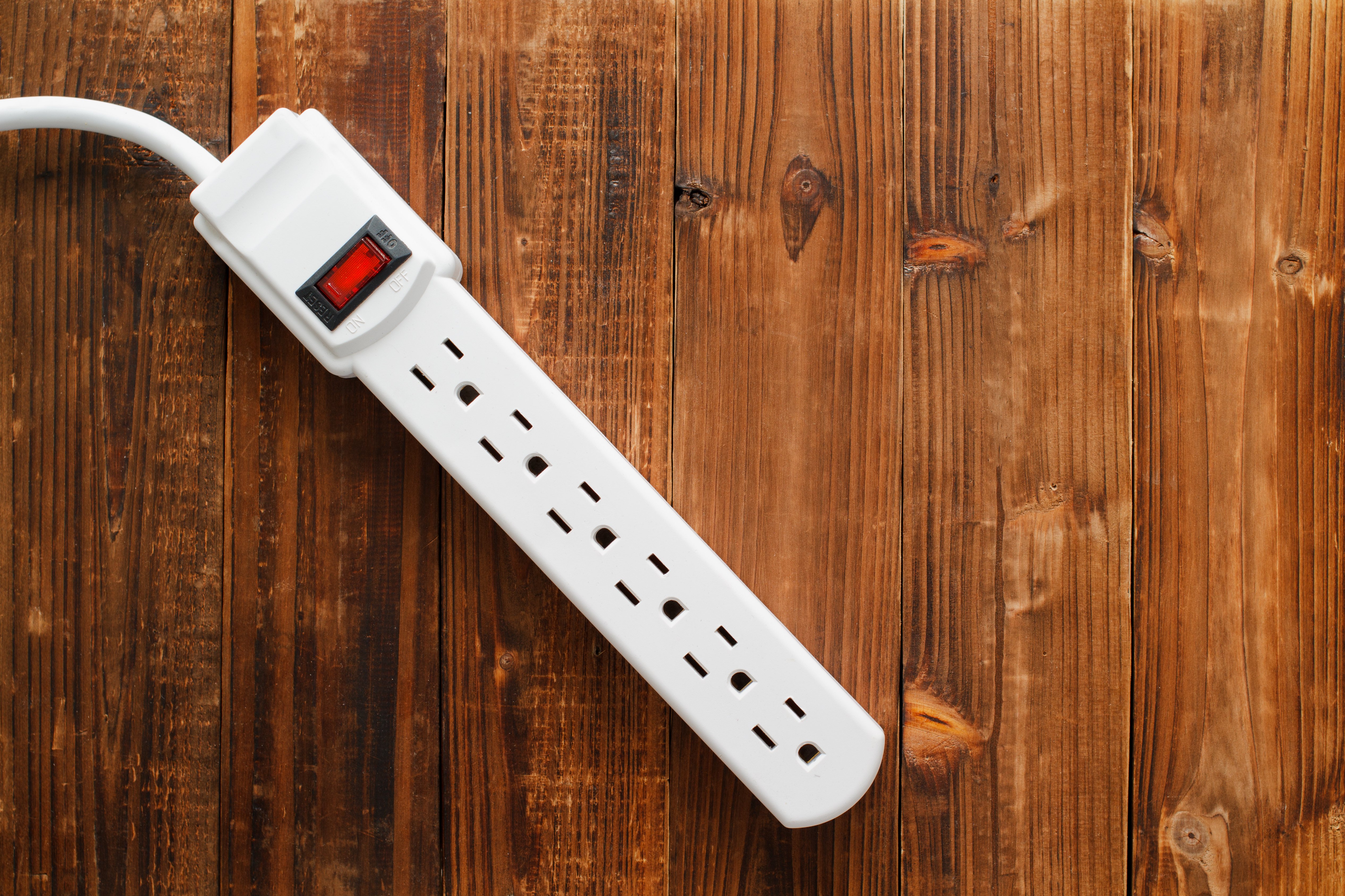 Electrical Power Bar on wooden background