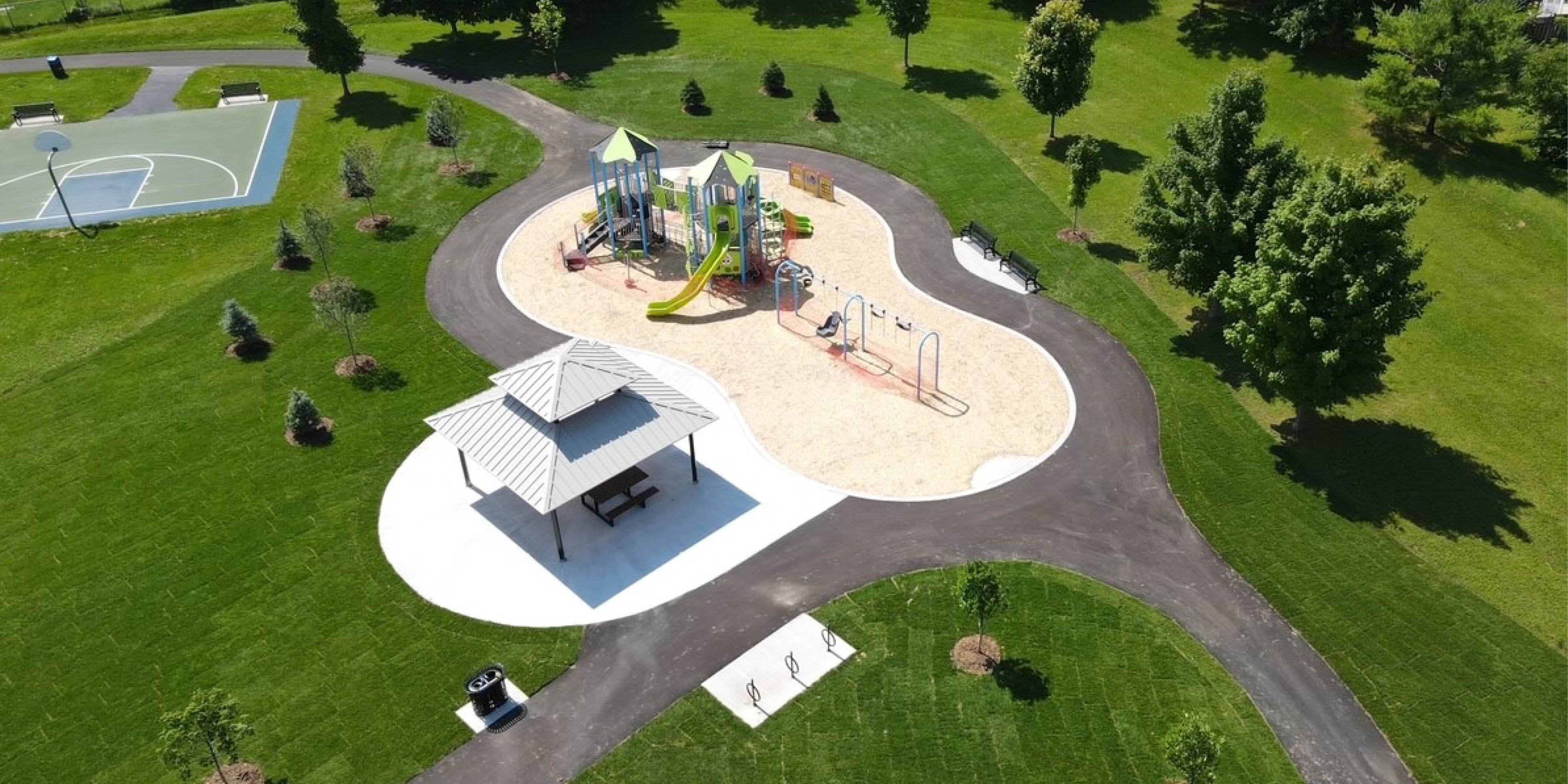 Overhead shot of King Street park playground, shade structure, walkway, trees and basketball court