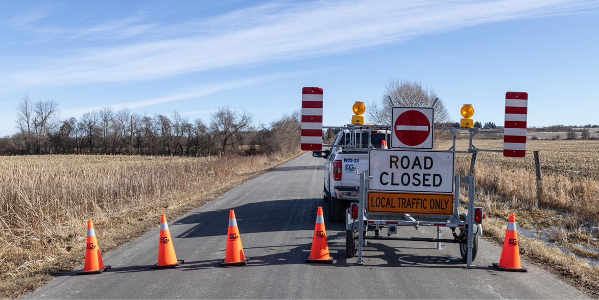 Rural road with road closed sign and traffic cones